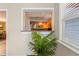 View from a pass-through into kitchen with stainless steel appliances and light wood cabinets at 2334 Tropical Shores Se Dr, St Petersburg, FL 33705