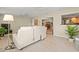 Spacious living room with tile flooring, white reclining furniture, and views of the kitchen and dining room at 2334 Tropical Shores Se Dr, St Petersburg, FL 33705