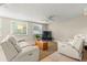 Comfortable living room featuring dual reclining sofas, neutral decor, and bright natural light at 2334 Tropical Shores Se Dr, St Petersburg, FL 33705