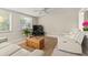 Comfortable living room featuring dual reclining sofas, neutral decor, and bright natural light at 2334 Tropical Shores Se Dr, St Petersburg, FL 33705