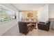 Living room with large bright windows, tile floors and 2 leather chairs at 2334 Tropical Shores Se Dr, St Petersburg, FL 33705
