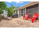 Charming brick patio area featuring vibrant red chairs and a well-maintained outdoor grilling space at 2334 Tropical Shores Se Dr, St Petersburg, FL 33705