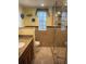 Updated bathroom with tiled shower, granite counters, and a window at 240 N Bayshore Blvd # 102, Clearwater, FL 33759