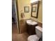 Cozy bathroom featuring a wood-trimmed mirror, and decorative wall art adding charm to the space at 240 N Bayshore Blvd # 102, Clearwater, FL 33759