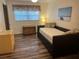 Cozy bedroom with wood-look floors, trundle bed, and chest at 240 N Bayshore Blvd # 102, Clearwater, FL 33759