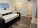 Cozy bedroom with daybed, wood-look floors, and plenty of sunlight at 240 N Bayshore Blvd # 102, Clearwater, FL 33759