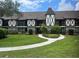 Attractive two-story condo with Tudor architecture, a manicured lawn, and a curved sidewalk at 240 N Bayshore Blvd # 102, Clearwater, FL 33759