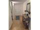 Bright condo foyer featuring neutral tile flooring, a console table with lamps, and a decorative rug at 240 N Bayshore Blvd # 102, Clearwater, FL 33759