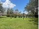 Well-maintained grounds showcase lush greenery, mature trees, and colorful flowers under a sunny sky at 240 N Bayshore Blvd # 102, Clearwater, FL 33759