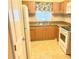 Efficient kitchen featuring wood cabinets, a stainless steel sink, and a bright window at 240 N Bayshore Blvd # 102, Clearwater, FL 33759