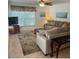 Cozy living room with a comfortable sofa, area rug, window with natural light, and a ceiling fan at 240 N Bayshore Blvd # 102, Clearwater, FL 33759