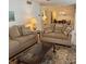 Warm living room featuring two sofas, a coffee table, an area rug, and a view of the dining area at 240 N Bayshore Blvd # 102, Clearwater, FL 33759