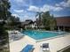 Community pool with lounge seating, surrounded by lush landscaping and well-maintained grounds at 240 N Bayshore Blvd # 102, Clearwater, FL 33759