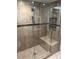 Glass shower with tile surround, built in niche, and shower seat at 240 N Bayshore Blvd # 102, Clearwater, FL 33759