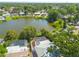 Stunning aerial view of the community, showcasing a serene lake, lush trees and pool at 2436 Beacon Groves Blvd, Palm Harbor, FL 34683