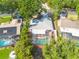 Aerial view of house with screened in pool with a large backyard and well-manicured landscaping at 2436 Beacon Groves Blvd, Palm Harbor, FL 34683