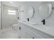 Modern bathroom with double sinks and a marble-tiled shower at 2436 Beacon Groves Blvd, Palm Harbor, FL 34683
