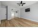 Bedroom features wood-look flooring and closet with mirror doors at 2436 Beacon Groves Blvd, Palm Harbor, FL 34683