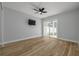 Light-filled bedroom featuring a sliding door and wood floors at 2436 Beacon Groves Blvd, Palm Harbor, FL 34683