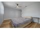 Comfortable bedroom featuring wood flooring and a ceiling fan at 2436 Beacon Groves Blvd, Palm Harbor, FL 34683