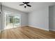 Bright bedroom with sliding door to screened pool area at 2436 Beacon Groves Blvd, Palm Harbor, FL 34683