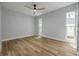This bedroom is well lit with windows and wood-look flooring at 2436 Beacon Groves Blvd, Palm Harbor, FL 34683