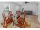 Open concept living/dining room with bright natural light, stylish rugs, and new floors at 2436 Beacon Groves Blvd, Palm Harbor, FL 34683