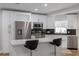 Bright kitchen featuring white cabinetry, stainless steel appliances, and a stylish breakfast bar with seating at 2436 Beacon Groves Blvd, Palm Harbor, FL 34683