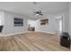Bright living space showcasing hardwood floors, neutral walls, and an open layout to a kitchen area at 2436 Beacon Groves Blvd, Palm Harbor, FL 34683