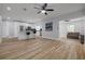 Bright, open-concept living space featuring hardwood floors, stainless appliances, and a large island with bar seating at 2436 Beacon Groves Blvd, Palm Harbor, FL 34683