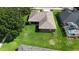 Aerial view of home and backyard featuring lush green lawn and mature trees at 2803 Abbey Grove Dr, Valrico, FL 33594