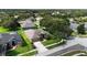 Aerial view of a beautiful home with a well-maintained lawn and mature landscaping in a quiet neighborhood at 2803 Abbey Grove Dr, Valrico, FL 33594