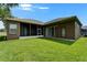 Spacious backyard featuring a well-manicured lawn, mature landscaping, and a screened lanai at 2803 Abbey Grove Dr, Valrico, FL 33594