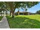 Beautiful backyard boasts mature landscaping, verdant lawn and a screened in lanai at 2803 Abbey Grove Dr, Valrico, FL 33594