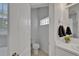 This half bath features a toilet and a white vanity with modern lighting at 2803 Abbey Grove Dr, Valrico, FL 33594