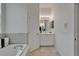 This bathroom features a soaking tub, a white vanity, and modern lighting at 2803 Abbey Grove Dr, Valrico, FL 33594