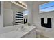 Bright bathroom with white marble countertop, vanity, mirror and stylish black and white shower curtain at 2803 Abbey Grove Dr, Valrico, FL 33594