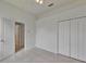 A tidy bedroom with tile floors, closet, and door leading to other rooms at 2803 Abbey Grove Dr, Valrico, FL 33594