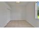 A simple, bright bedroom with tile flooring, and a window with exterior view at 2803 Abbey Grove Dr, Valrico, FL 33594