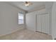 A bright bedroom with tile floors, a window with blinds, and a double-door closet at 2803 Abbey Grove Dr, Valrico, FL 33594