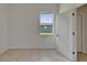 A simple bedroom with tile floors, a large window, and white trim at 2803 Abbey Grove Dr, Valrico, FL 33594
