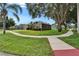 Charming home exterior boasts verdant lawn, mature landscaping, and inviting curb appeal at 2803 Abbey Grove Dr, Valrico, FL 33594