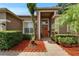Inviting front entrance featuring a beautifully landscaped walkway leading to a welcoming front door and manicured shrubbery at 2803 Abbey Grove Dr, Valrico, FL 33594