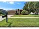 Well-maintained home features a lush lawn, mature trees, and a welcoming front entrance at 2803 Abbey Grove Dr, Valrico, FL 33594