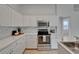 Bright kitchen features white cabinets, granite countertops, and stainless steel appliances at 2803 Abbey Grove Dr, Valrico, FL 33594