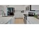 Modern kitchen with stainless steel appliances, white cabinetry and marble backsplash at 2803 Abbey Grove Dr, Valrico, FL 33594