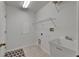 Bright laundry room with utility sink, shelving and tile flooring for easy maintenance at 2803 Abbey Grove Dr, Valrico, FL 33594
