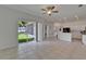 Bright living room with sliding glass doors and neutral tile flooring throughout at 2803 Abbey Grove Dr, Valrico, FL 33594