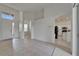 Open-concept living area with tiled floors, archways and a view into the kitchen at 2803 Abbey Grove Dr, Valrico, FL 33594
