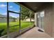 View of green lawn from the home's tiled and screened back patio at 2803 Abbey Grove Dr, Valrico, FL 33594